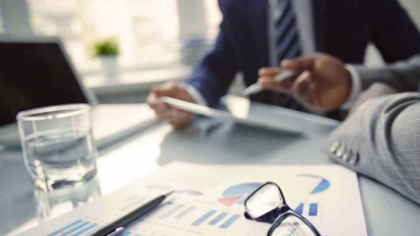 Close up of glasses with a background of two businessmen